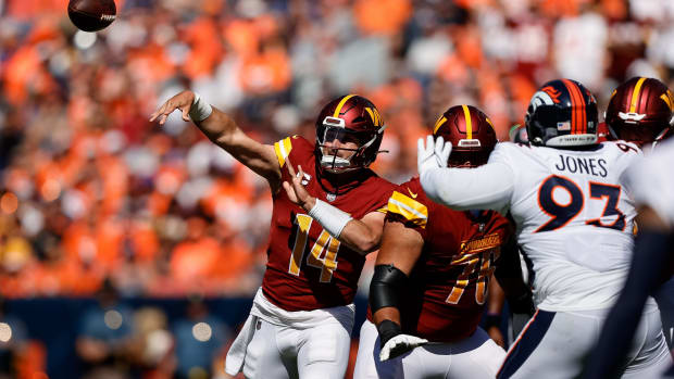 Sep 17, 2023; Denver, Colorado, USA; Washington Commanders quarterback Sam Howell (14) attempts a pass as offensive tackle Sam Cosmi (76) defends against Denver Broncos defensive tackle D.J. Jones (93) in the first quarter at Empower Field at Mile High. Mandatory Credit: Isaiah J. Downing-USA TODAY Sports